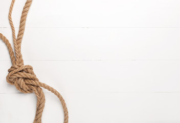 Jute rope on white wooden background.