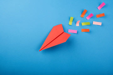 Red paper plane on the blue background
