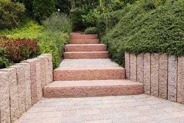 Neat and tidy front yard with solid block steps, decorative gravel and planting