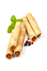 Wafer rolls with condensed milk, homemade sweets, isolated on white background