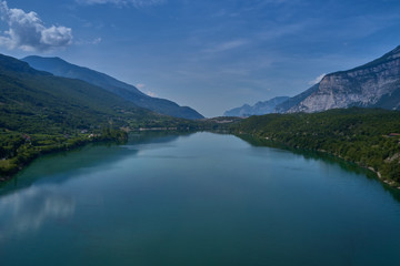 Naklejka na ściany i meble Aerial photography. Panoramic view of a small lake north of Italy. Trento region. Great trip to the lake in the Alps.