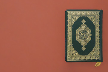 Quran on a plain burgundy background
