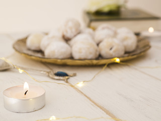 Defocused cookie plate with candle and quran