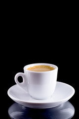 Espresso black coffee - made in a coffee machine with thick crema, of uniform golden-peanut color.