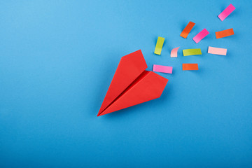 Red paper plane on the blue background