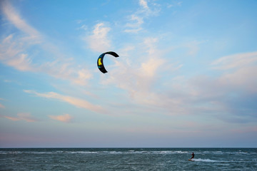 a surfer kite surfing the waves
