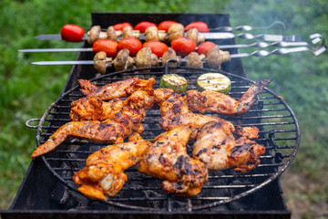 Vegetables and grilled chicken meat. tomatoes, mushrooms and zucchini. Chicken on open fire. Summer barbecue party.