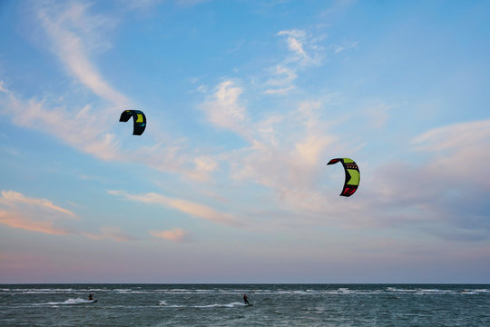 Two kayters riding on the waves