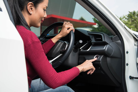 Woman Push Start Engine Button In Her Car.