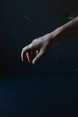 Obraz na płótnie Canvas Human hand on a black background, in the dark
