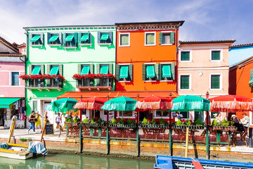 Fototapeta na wymiar bright colorful picturesque buildings near a chanel of Venice , houses of Burano in the evening