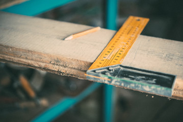 Length measurement using a metal ruler-corner on a wooden Board,carpentry