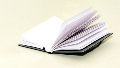 open hardcover notebook on a white table.