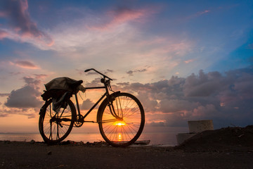 Fototapeta na wymiar sunset view with silhouette bicycle