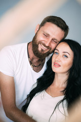 Fototapeta premium Loving couple woman and man with beard soft light from window