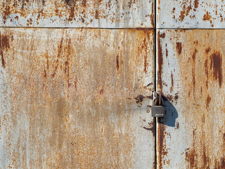 rusty lock hanging on old iron gate