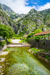 Monenegro, View to majestic mountains next to kotor bay city seen from river gate at old town city gate in summer