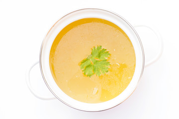 Pot of chicken broth isolated on white background.