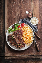Grilled lean T-bone steak with golden potato chips