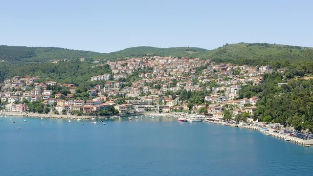 Panoramic Aerial view from the sea of Rabac, Croatia. Amazing resort town on Kvarner Bay. European City Perched seaside, Croatian Touristic destination with crystal clear blue water in Mediterranean.