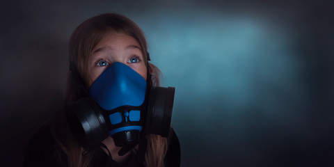 Young girl wearing gasmask, respirator portrait. Effects of worldwide air pollution, industrial...