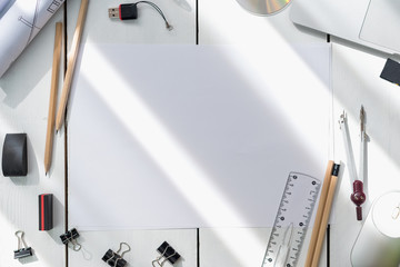 Architectural plans, pencil and ruler on the table. Laptop and accessories. Place for your text.