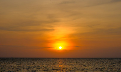 Obraz premium Bright orange sky and light of the sun. Sky background on sunset. Nature composition. Panoramic sunset sky background. Sunset sky with lighted clouds. Beauty evening sunset.