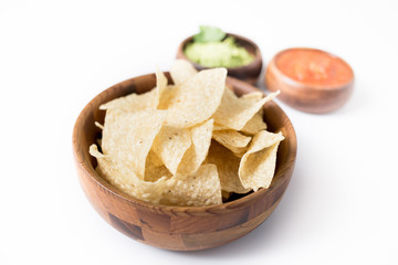 Chips with salsa and guacamole on white background