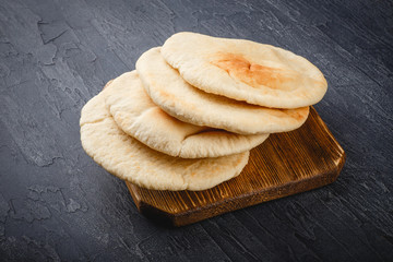 Pita bread on wooden board