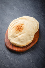 Pita bread on wooden board