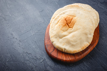 Pita bread on wooden board