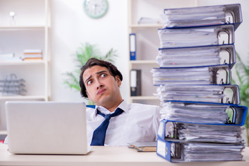 Young male employee unhappy with excessive work