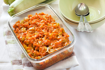 Squash stew with carrot and tomatoes in a square glass dish