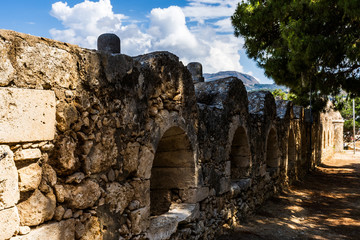 Stony wall with small windows in historical attraction Crete, Greece