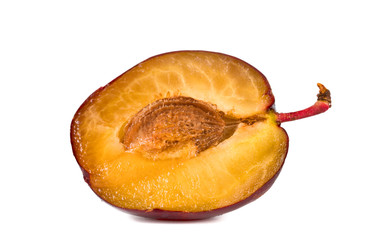 half plums with stone isolated on white background