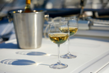 Pair of wineglasses against the yacht