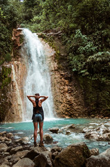 Girl enjoying a waterfall
