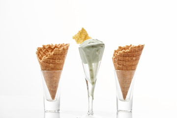 Fototapeta na wymiar fresh crispy sweet waffle cones and pistachio ice cream isolated on white