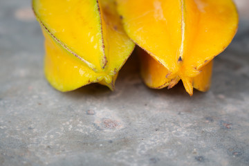 Ripe Star apple on dark wooden background or Star-fruit on dark wooden table