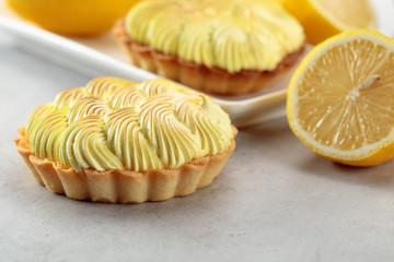 Tartlets with lemon cream on a white table.
