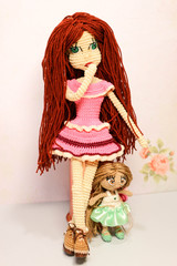Beautiful cute funny handmade crochet knitted dolls big and small on white background closeup