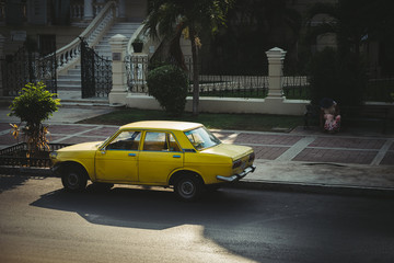 Fototapeta na wymiar an old yellow car parked