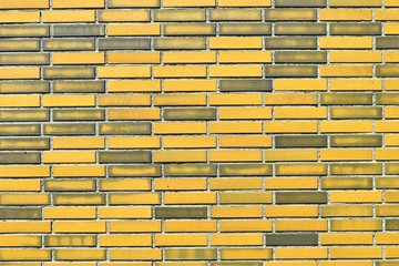 Yellow brick walls with old and weathered stones and cracks im high resolution