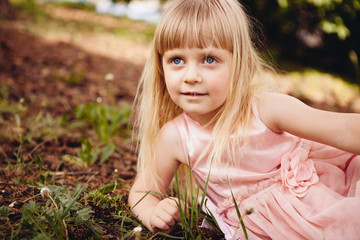 Curious little girl playing and smiling, portrait of child