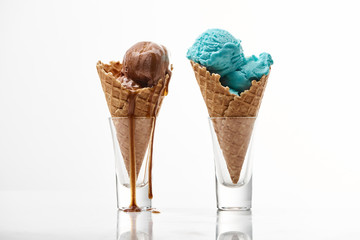 delicious sweet chocolate and blue ice cream in crispy waffle cones isolated on white