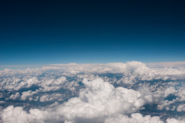 Above view from plane on blue sky and clouds