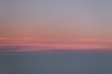 Pink, Orange, and blue sunrise outside of plane window, Plane view of beautiful sunset