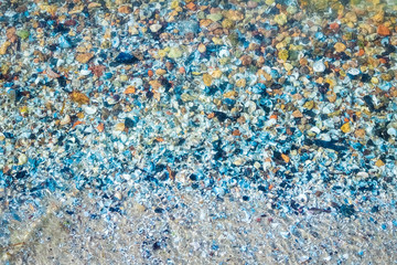 sea bottom with lots of shells, pebbles and multi-colored stones
