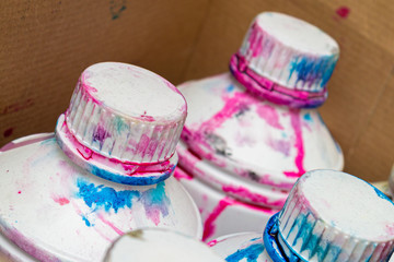 dirty cans in a multi-colored printer ink