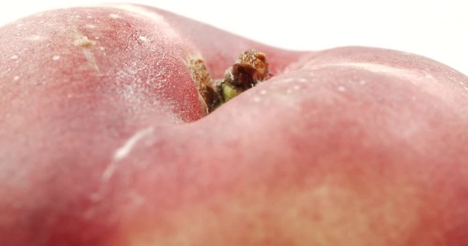 Donut peach isolated rotates on itself on white background. Snuffbox, Saturn, Tabacchiera rotation. Organic fruit.